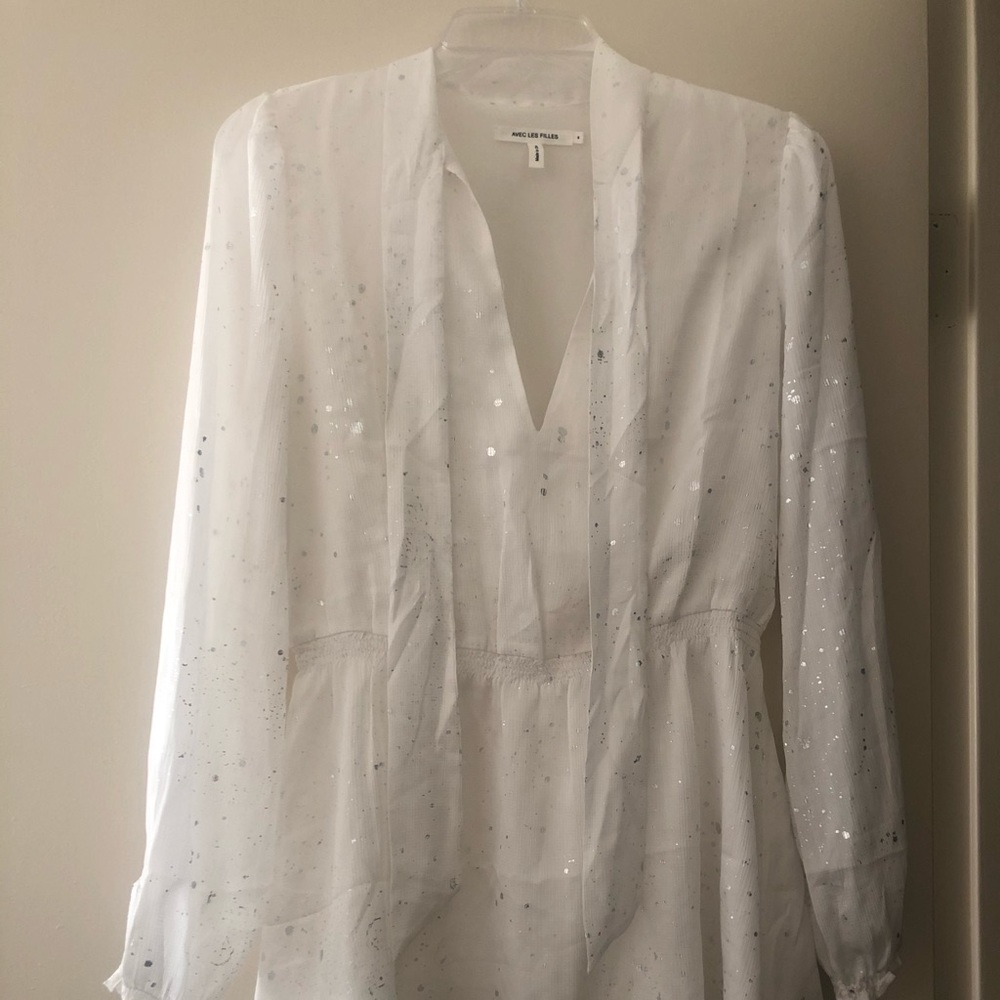White long sleeve dress with silver dashes.